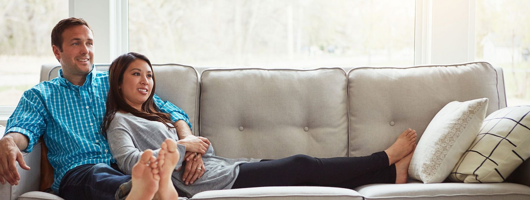 Morgan Place husband and wife sitting on sofa