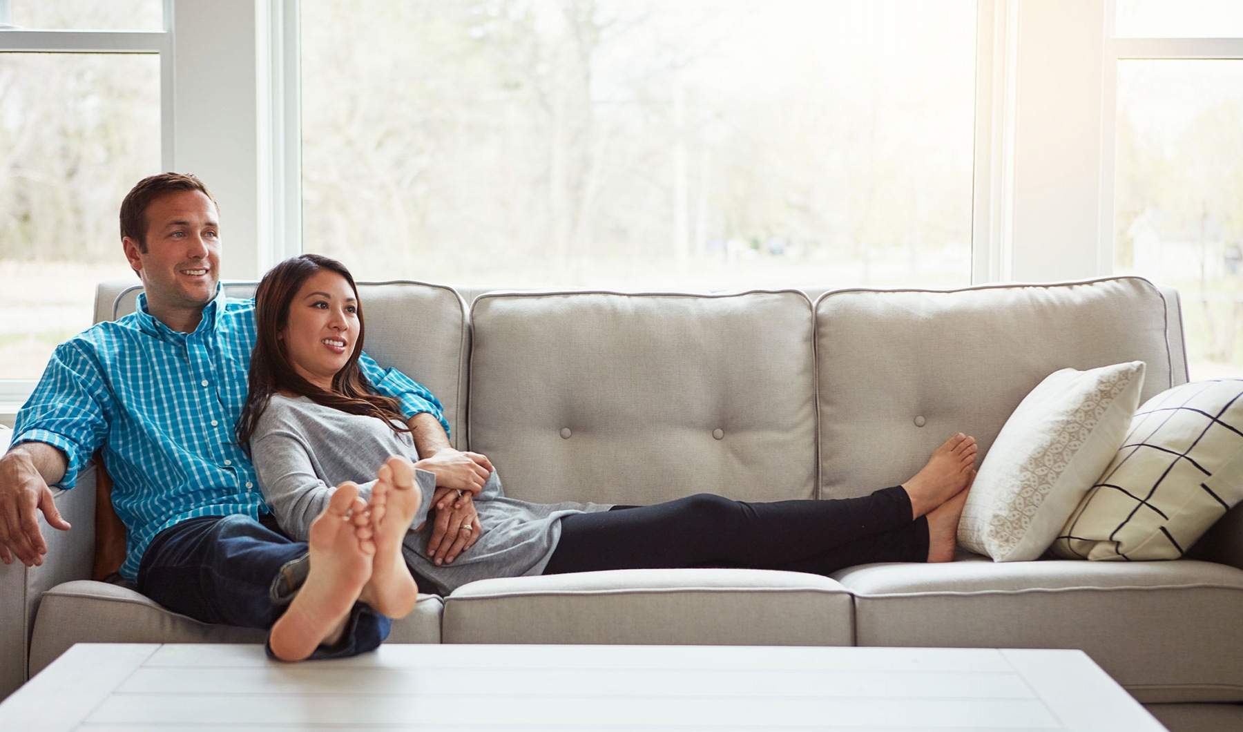 Morgan Place husband and wife sitting on sofa
